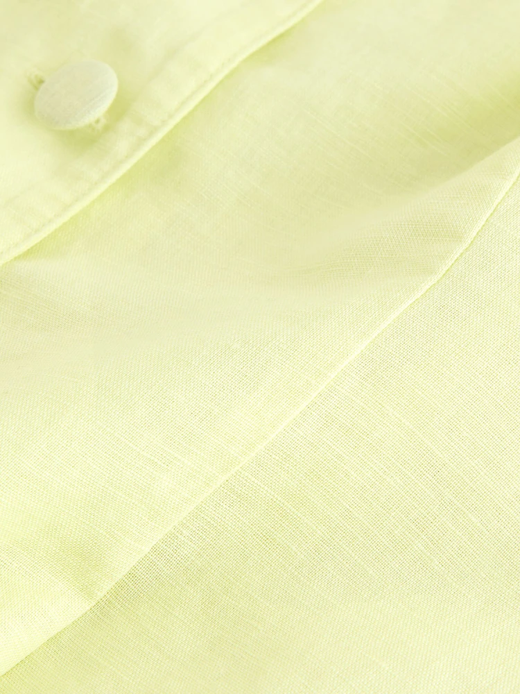 Pale yellow linen cotton short sleeve button front top with fabric-covered buttons and shaped waist