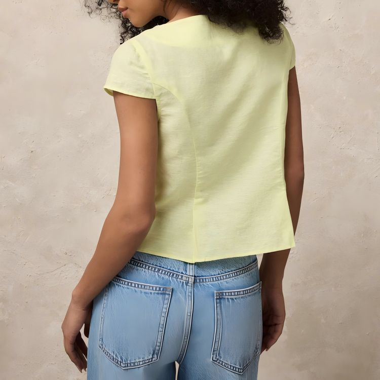Pale yellow linen cotton short sleeve button front top with fabric-covered buttons and shaped waist