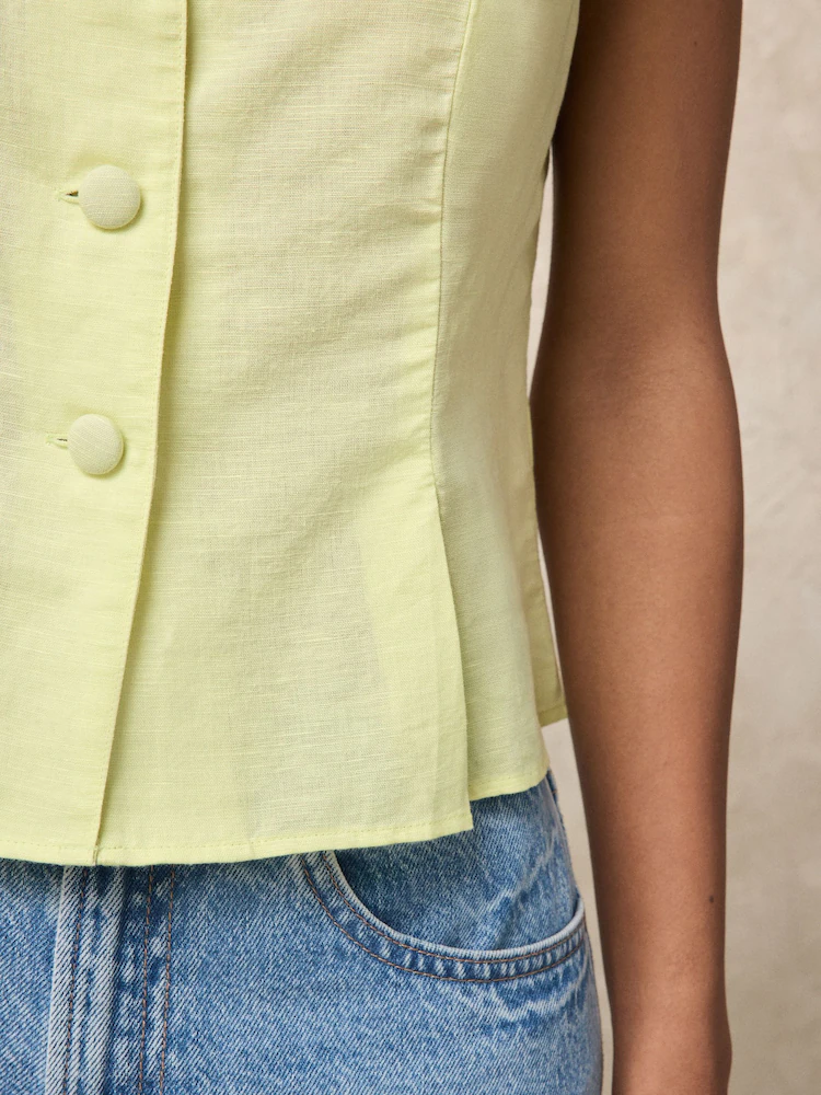 Pale yellow linen cotton short sleeve button front top with fabric-covered buttons and shaped waist
