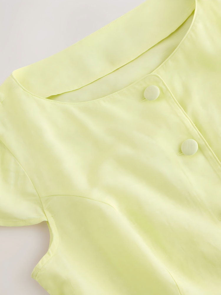 Pale yellow linen cotton short sleeve button front top with fabric-covered buttons and shaped waist