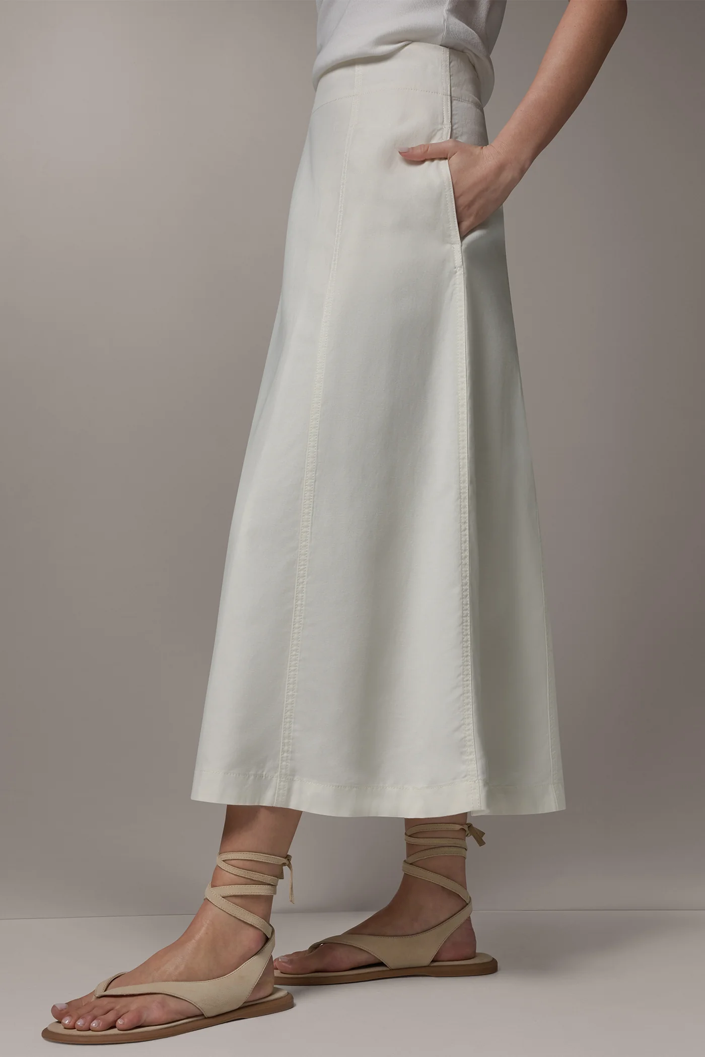 Off-white panelled A-line midi skirt with side pockets and a back zipper