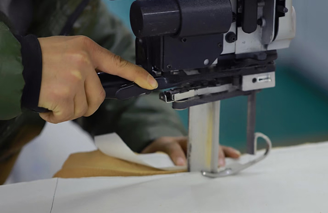 After the fabric is approved, it is cut. The factory cuts the material as per the final design, ensuring minimal wastage and accuracy in size. The standardized cutting process is vital to ensure that the garments are consistent and of good quality.