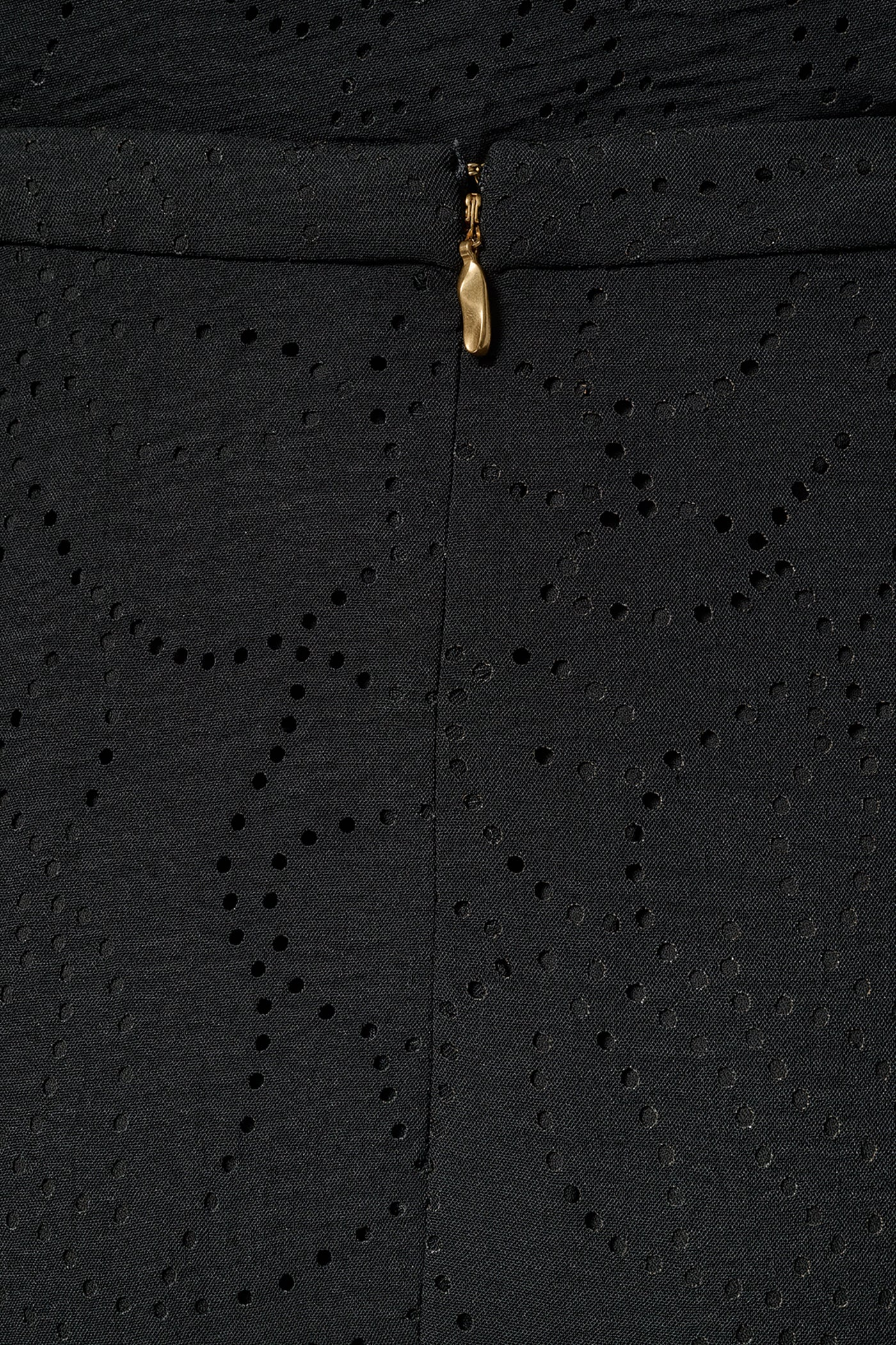 Black laser-cut A-line midi skirt with leaf motifs, an asymmetric hem and a back zipper