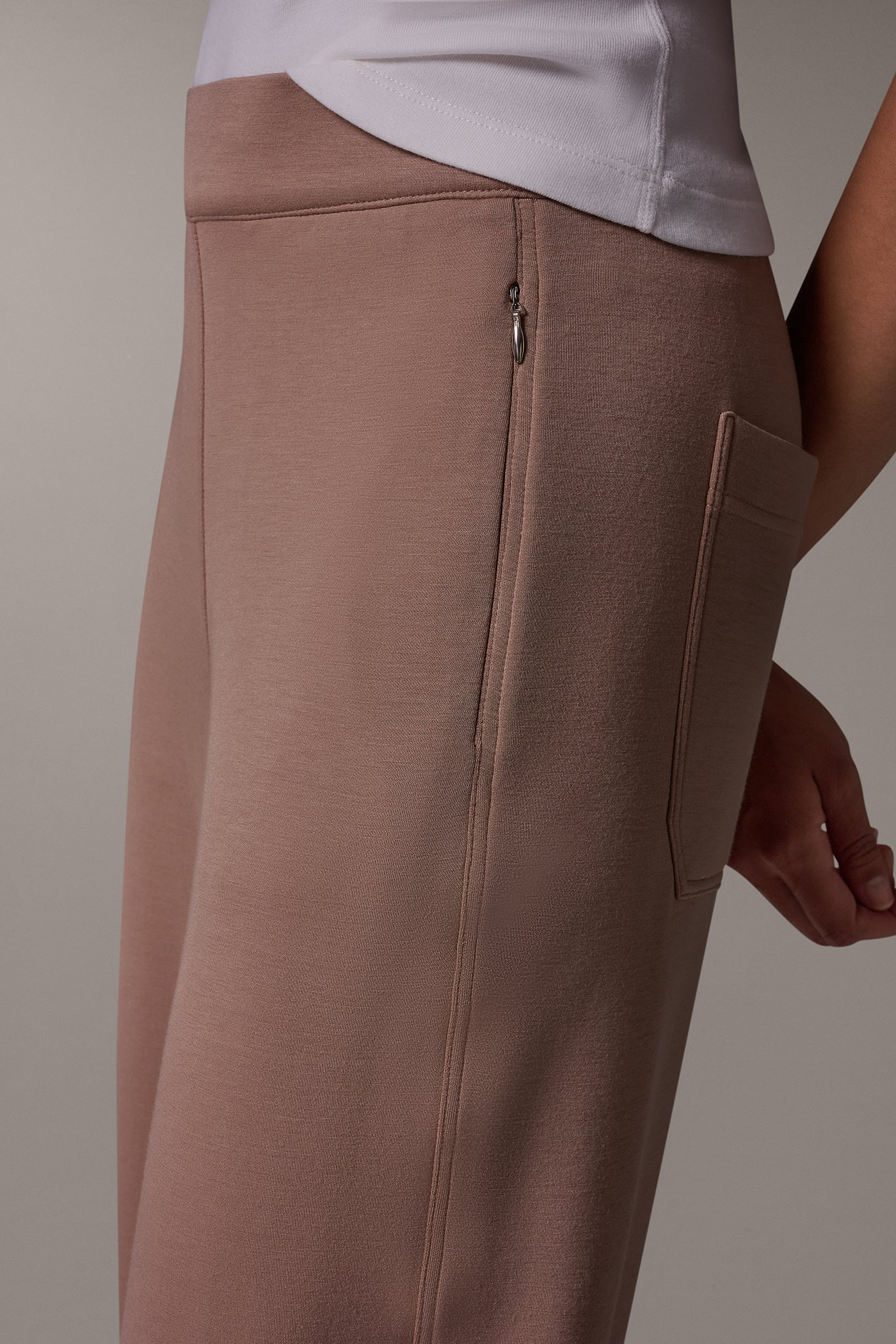 Dusty brown straight leg pants with zipped side pockets and back patch pockets