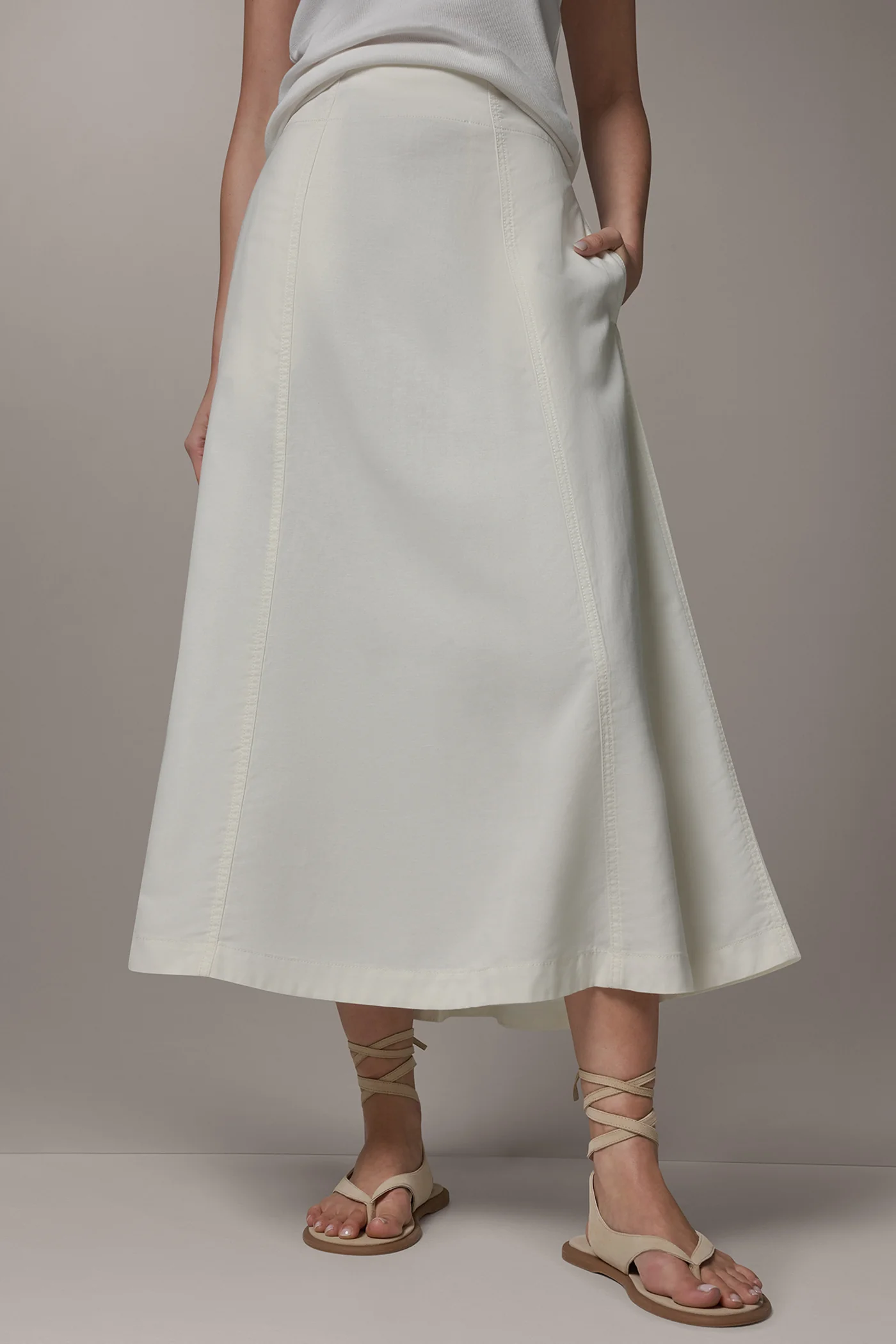 Off-white panelled A-line midi skirt with side pockets and a back zipper